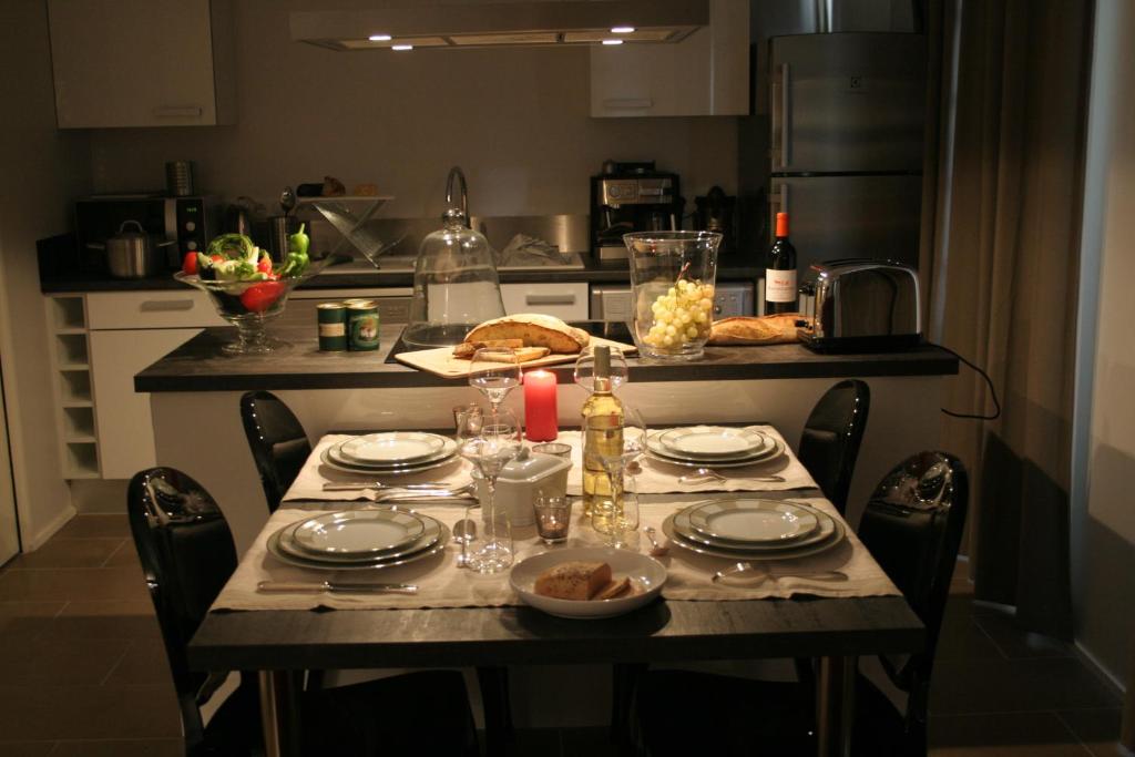 a kitchen with a table with plates and food on it at Le Porche de Sarlat in Sarlat-la-Canéda