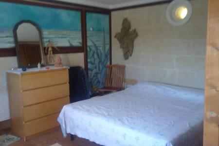 a bedroom with a bed and a dresser and a mirror at Il rifugio dell'Artista in Maruggio