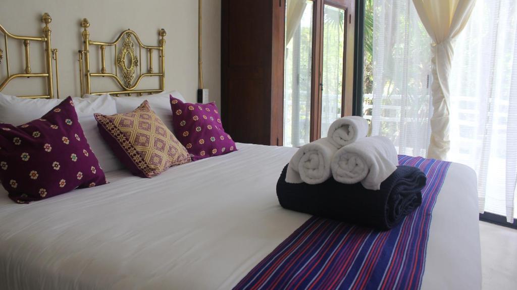 a bedroom with a bed with towels on it at Casa Ambar Tulum - Great Location in Tulum