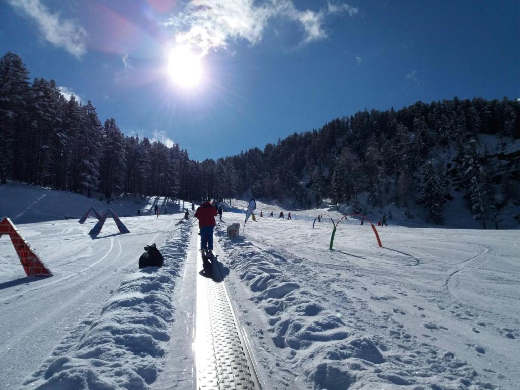 a group of people skiing down a snow covered slope at Casa Federica in Valdidentro