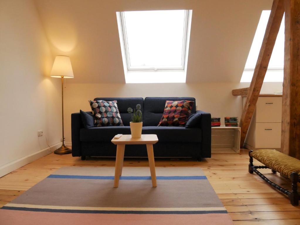 a living room with a couch and a table at Cityhouse Nauwies in Saarbrücken