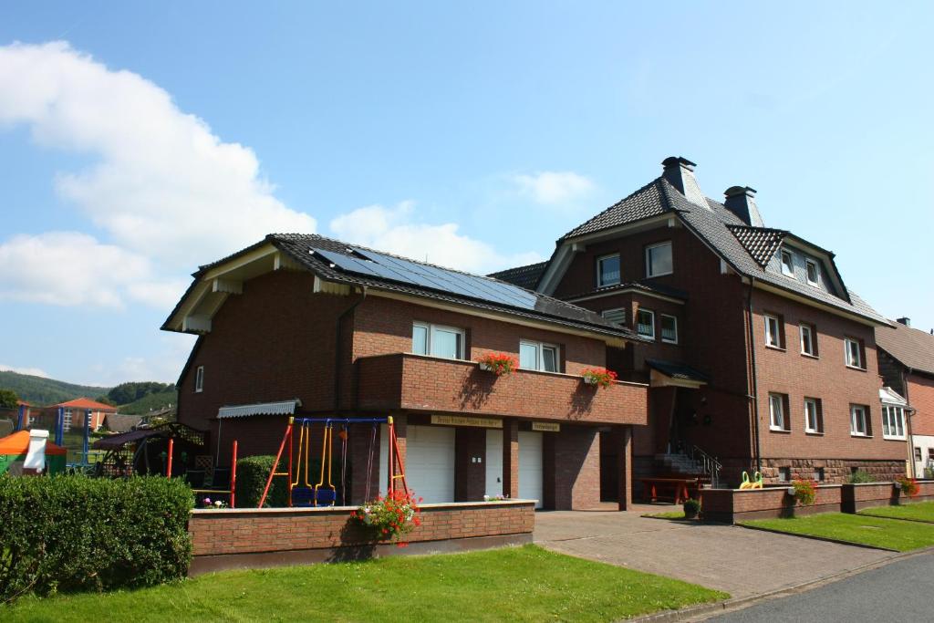 a large brown house with a gambrel roof at Ferienhaus Ahlborn in Uslar