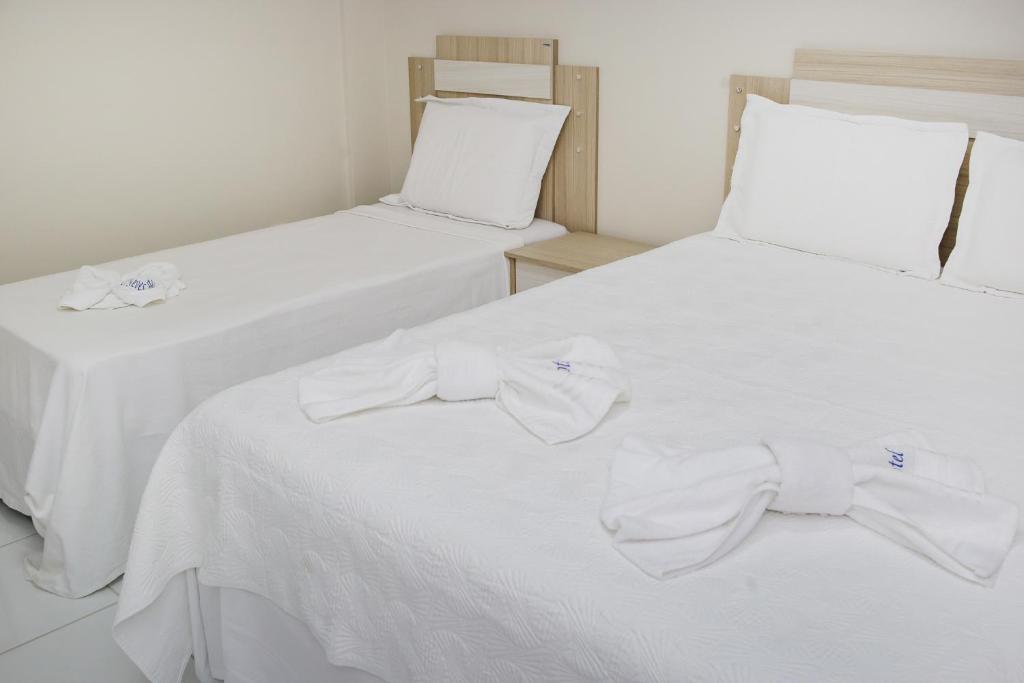 Postel nebo postele na pokoji v ubytování O Neves Hotel