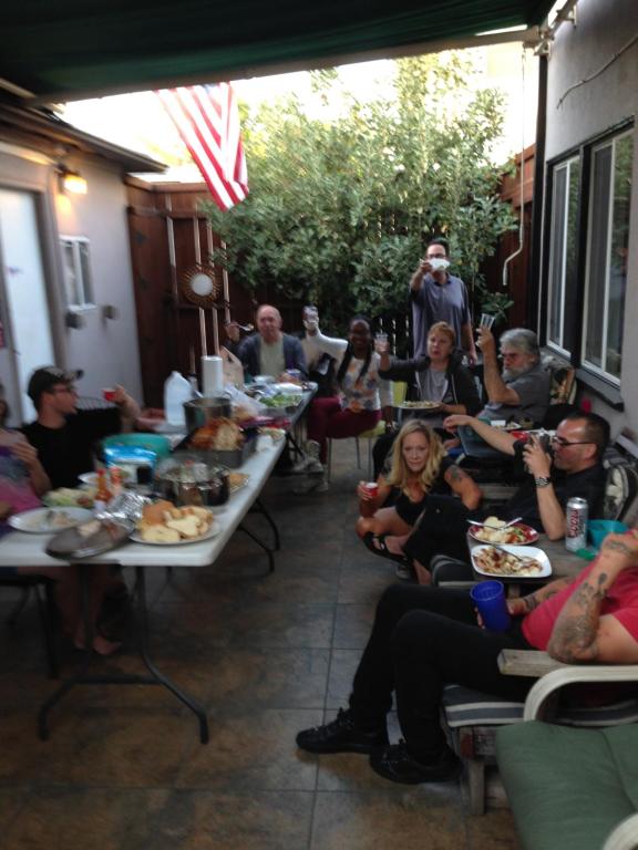 a group of people sitting at tables eating food at Timen house in North Hollywood