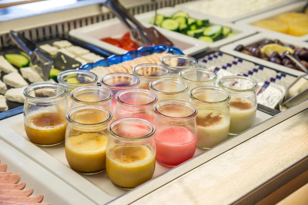 a bunch of glasses filled with different types of juice at Kordistos Hotel in Kefalos
