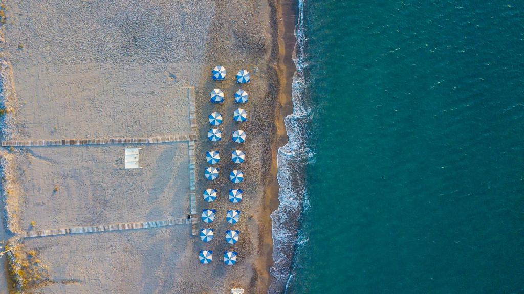 an overhead view of a beach with a group of parked cars at Kordistos Hotel in Kefalos
