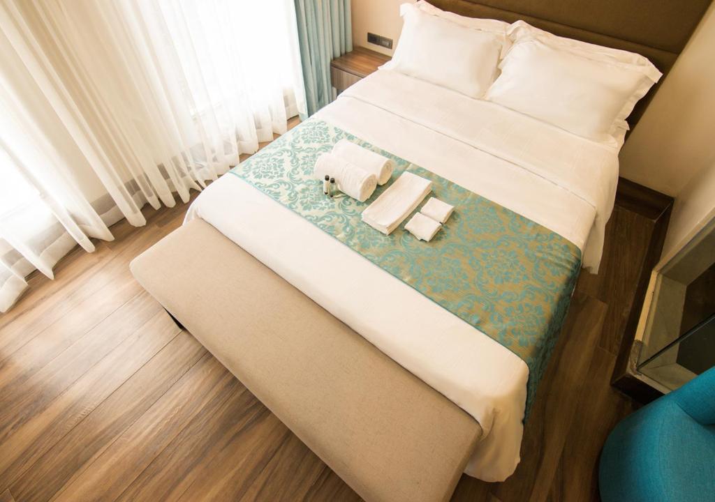 Postel nebo postele na pokoji v ubytování Goldberry Lite Hotel