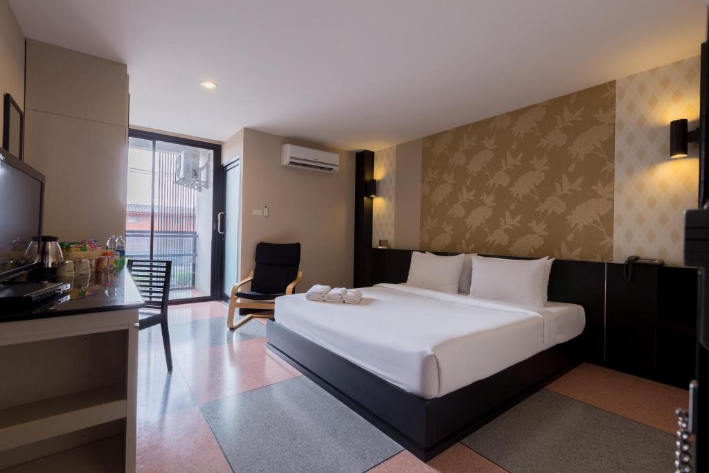 Postel nebo postele na pokoji v ubytování Pen Ta Hug Hotel