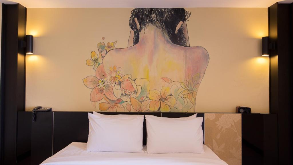 Postel nebo postele na pokoji v ubytování Pen Ta Hug Hotel
