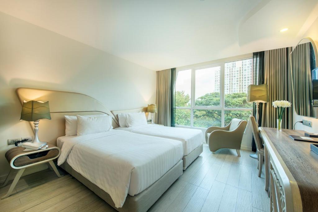 Postel nebo postele na pokoji v ubytování Le Tada Parkview Hotel