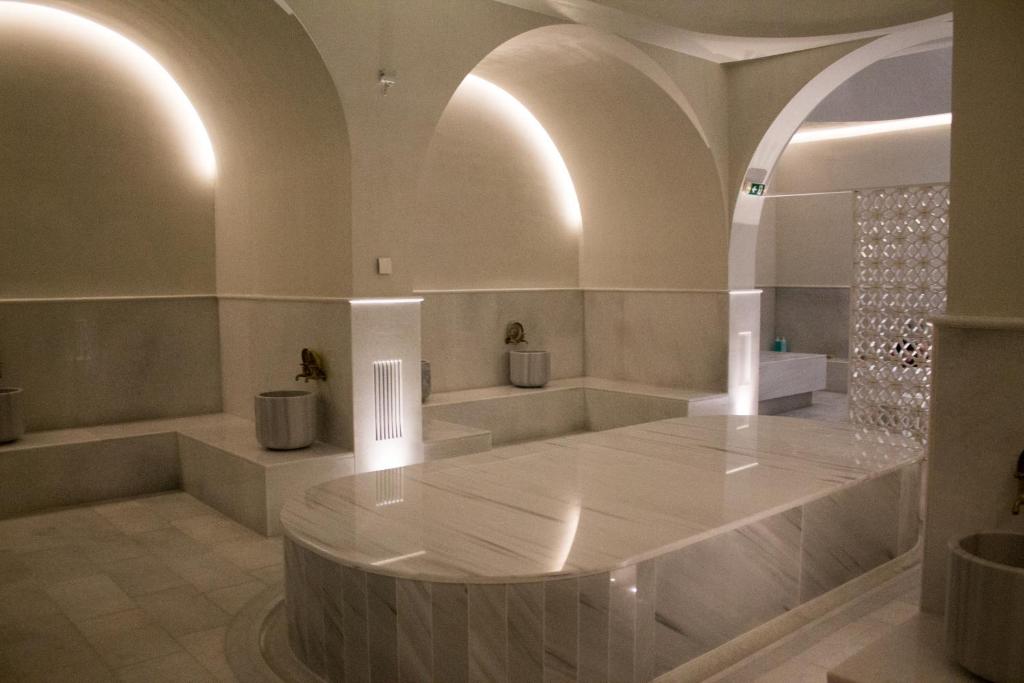 a large white room with a large marble floor at Makedonia Palace in Thessaloniki