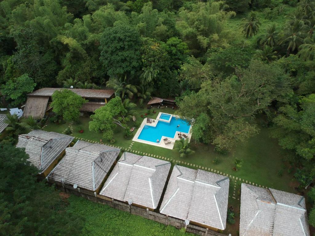 an overhead view of a house with a pool and trees at La Natura Resort in Coron