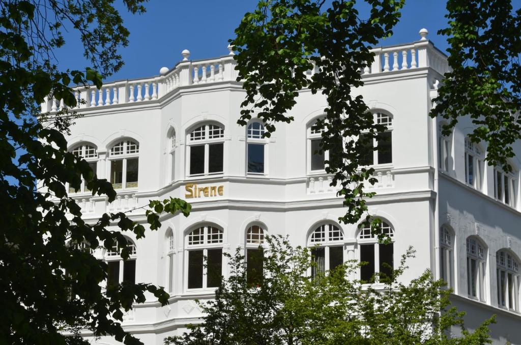 a white building with a sign on it at Villa Sirene - Wohnung 08 in Binz