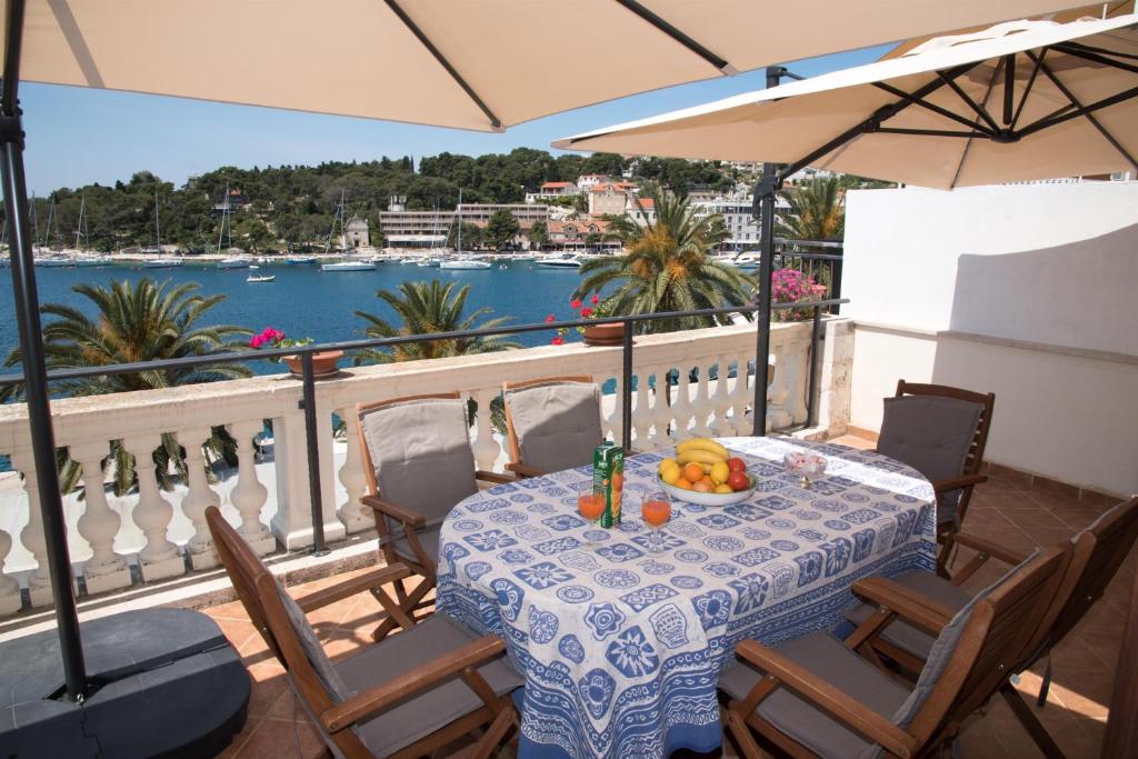 a table on a balcony with a view of the water at Holiday Home Meditation in Hvar