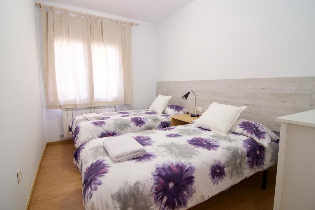 Postel nebo postele na pokoji v ubytování Apartaments IXA