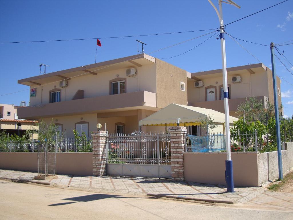 a house with a fence in front of it at Ksamil Harmony Studios in Ksamil