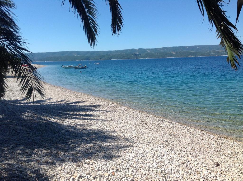 uma praia com dois barcos na água em Beach Penthouse Diamond em Omiš