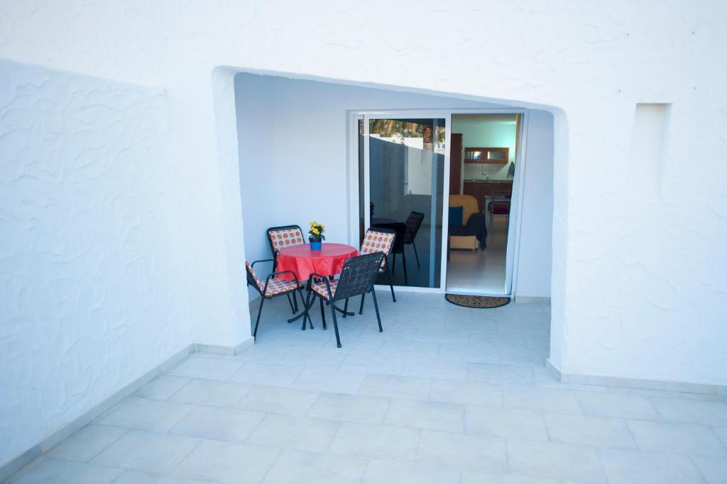 a dining room with a red table and chairs at Casa Lola in Agaete