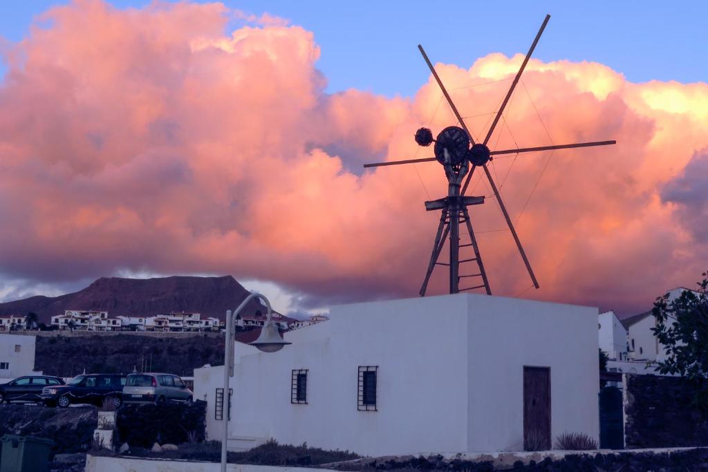 a windmill sitting on top of a white building at Casa Lola in Agaete