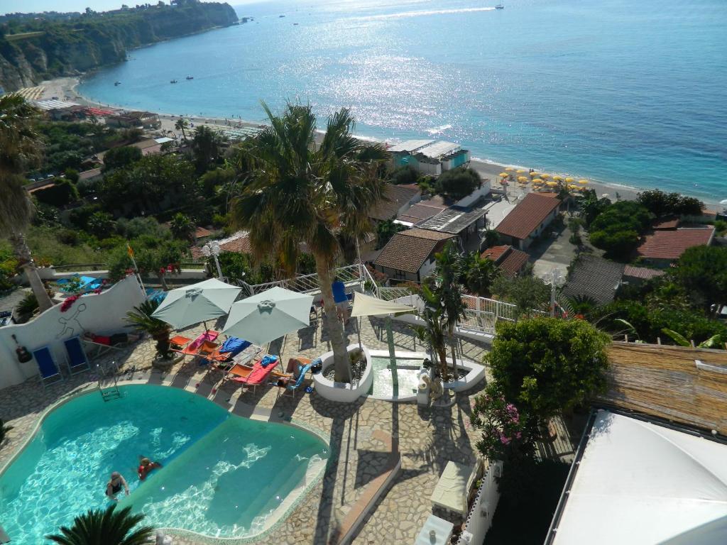 a view of the beach from the balcony of a resort at La Porta del mare SPA in Tropea