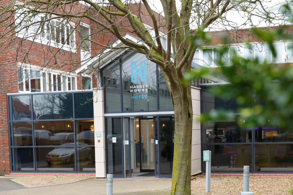 a building with a tree in front of it at Harben House in Milton Keynes