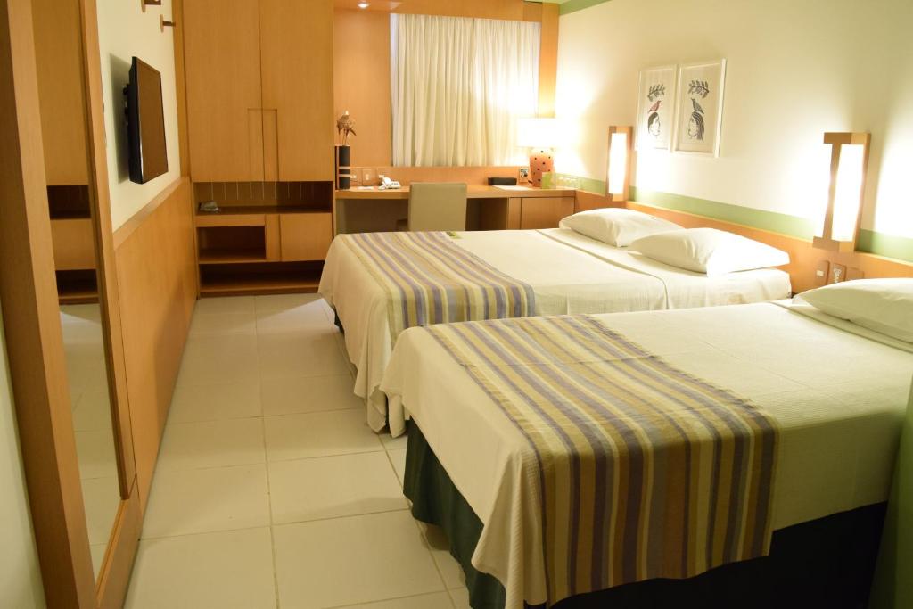 Postel nebo postele na pokoji v ubytování Verdegreen Hotel