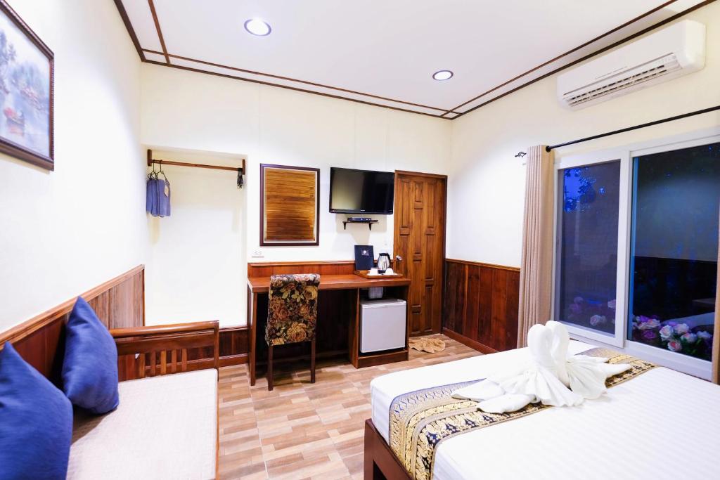Postel nebo postele na pokoji v ubytování Vieng Tawan Sukhothai Hotel