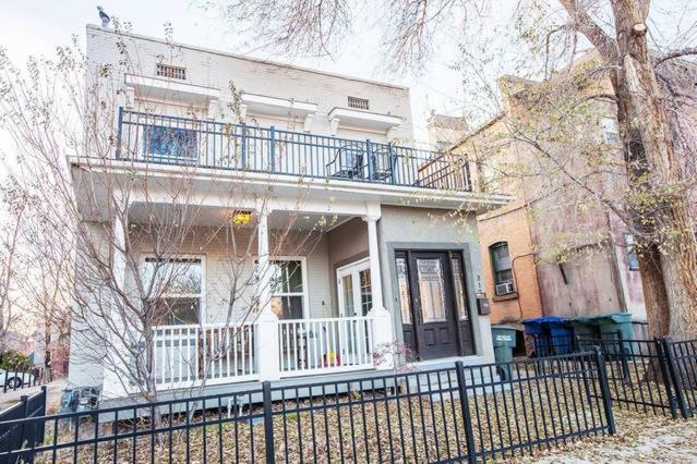 a white house with a balcony and a fence at Home in Heart of Salt Lake City Home in Salt Lake City