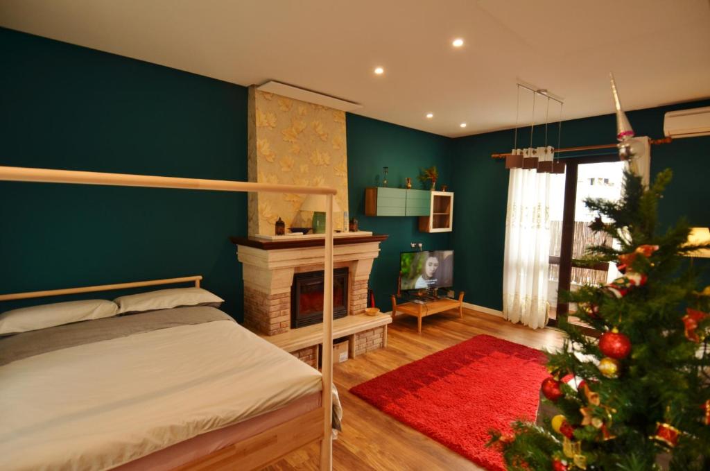 a bedroom with a christmas tree and a bed at Villa Berberi in Tirana