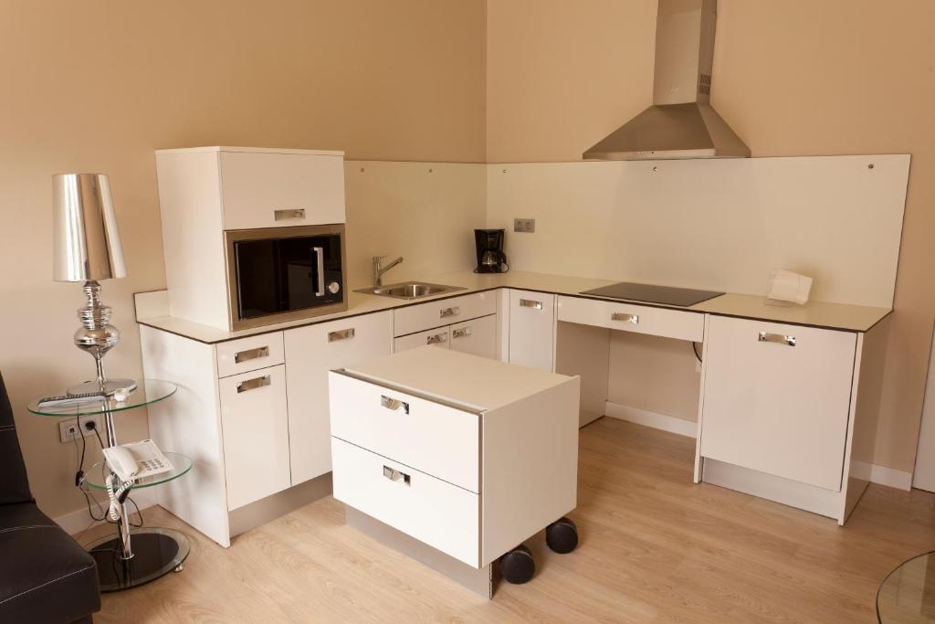 Kuchyň nebo kuchyňský kout v ubytování RuralSuite Hotel Apartamentos