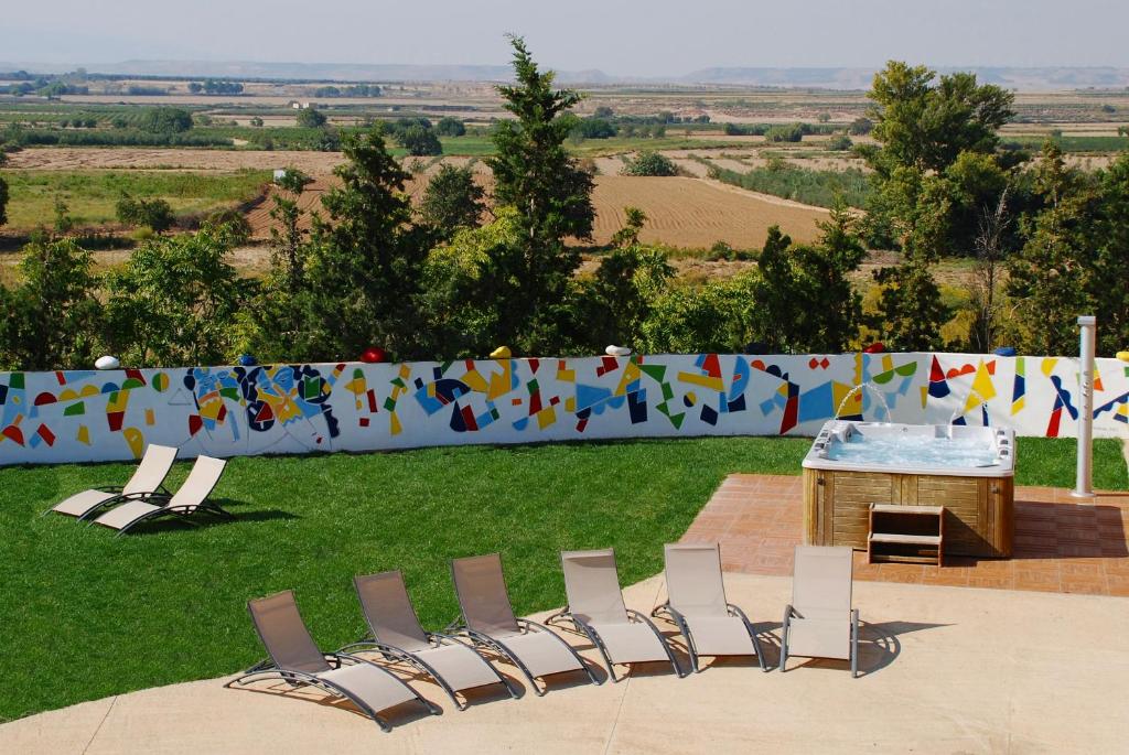 a group of chairs and a table and a fence at RuralSuite Hotel Apartamentos in Cascante