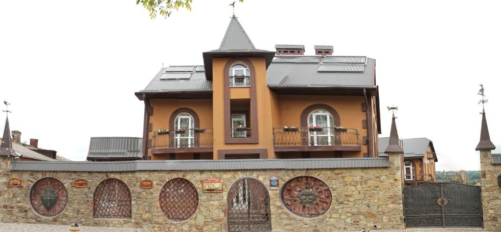 una casa con una torre en la parte superior de un edificio en Sadyba Smotrytska Perlyna, en Kamianets-Podilskyi
