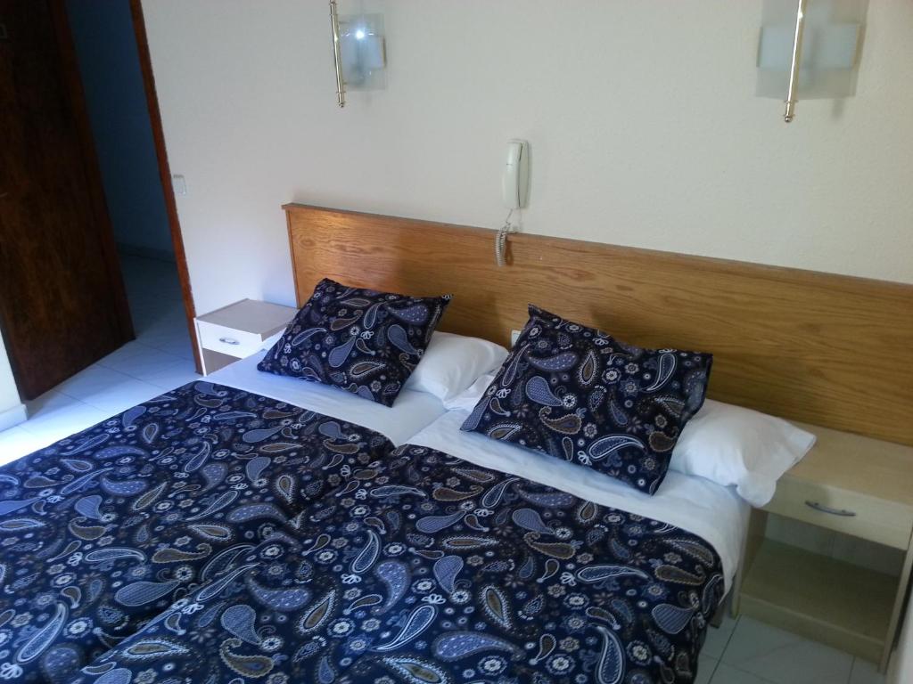 Postel nebo postele na pokoji v ubytování Hotel Arinsal