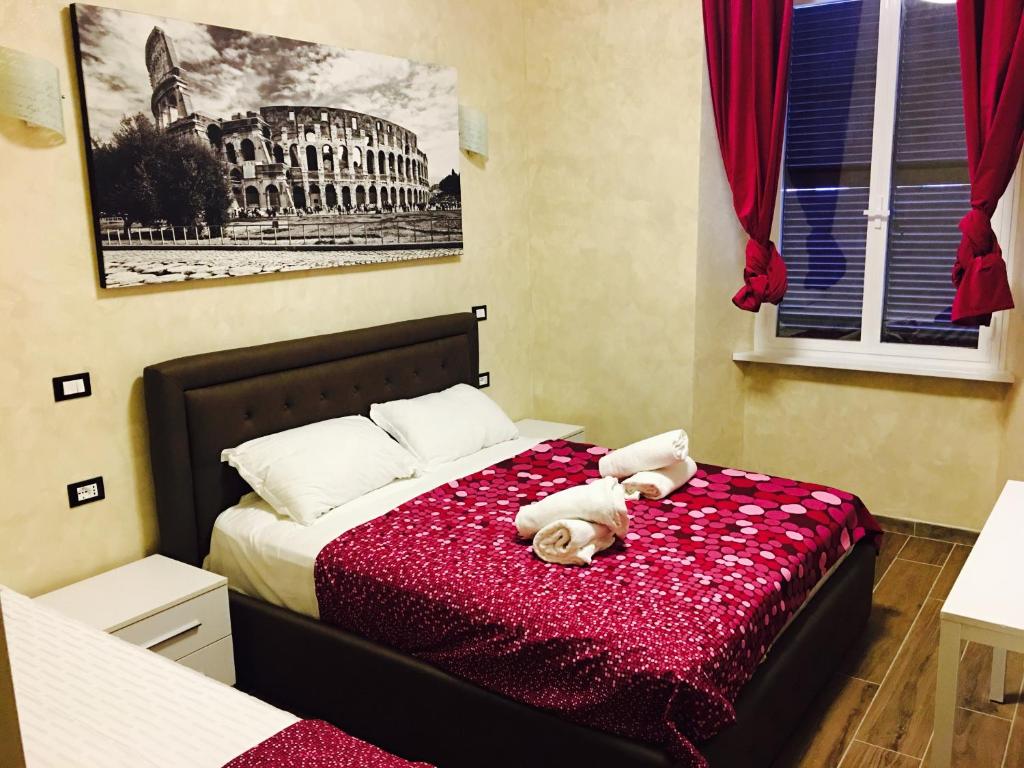 un orsacchiotto che giace su un letto in una camera da letto di Favola Romana - Guest House a Roma