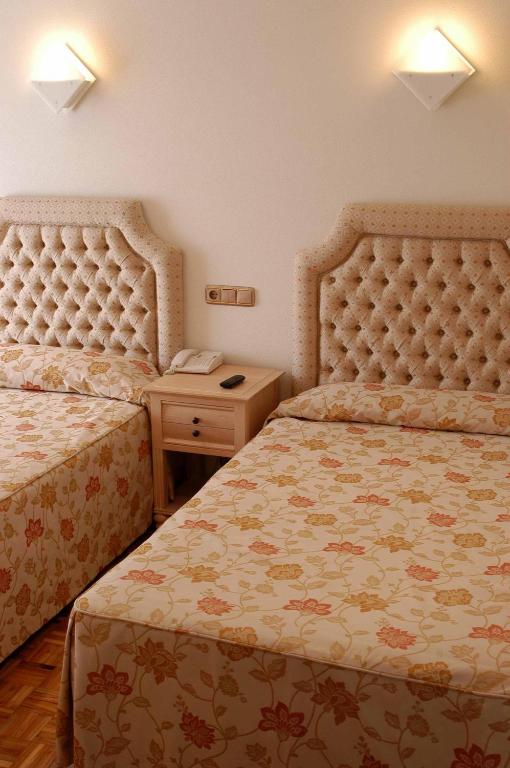 Postel nebo postele na pokoji v ubytování Hotel Julia