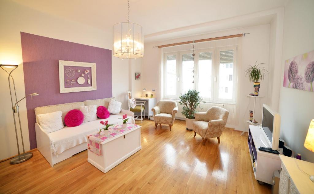 a living room with a white couch and a purple wall at Downtown in Zagreb