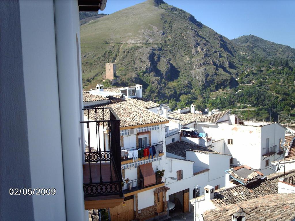 a view from a window of a town with a mountain at Casa Herron in Cazorla