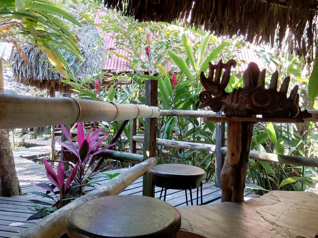 a wooden table topped with a wooden bench at Casa Bambután in Palenque