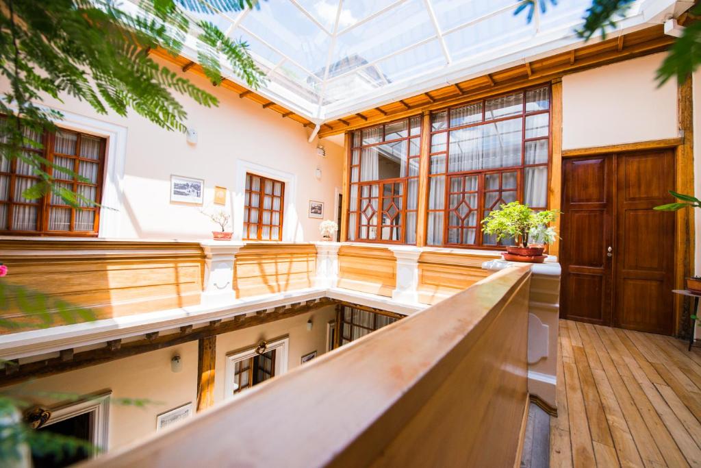 a large room with a glass ceiling and a hallway at Casa El Edén in Quito