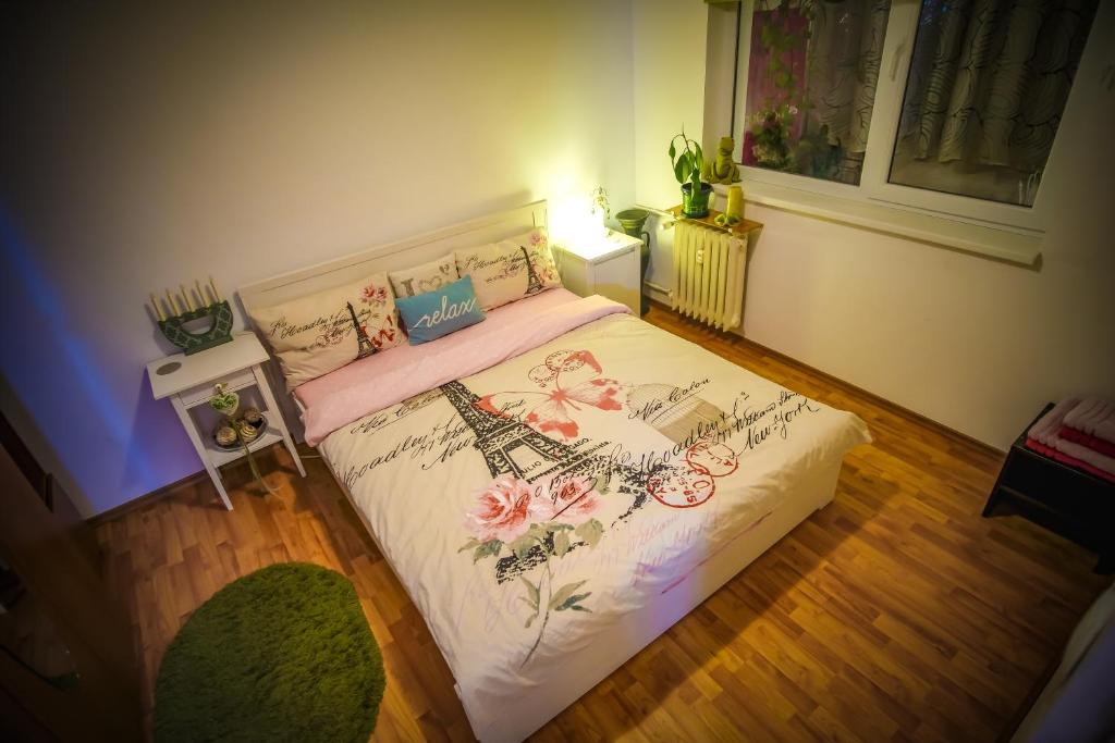 - une chambre dotée d'un lit avec un couvre-lit floral dans l'établissement Mozaic Home, à Bucarest