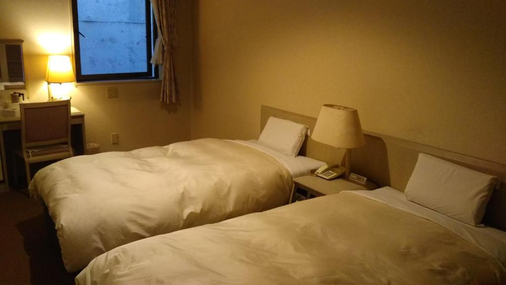 Postel nebo postele na pokoji v ubytování Hotel Hitachi Hills