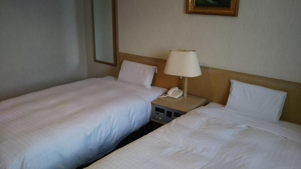 Postel nebo postele na pokoji v ubytování Hotel Hitachi Hills