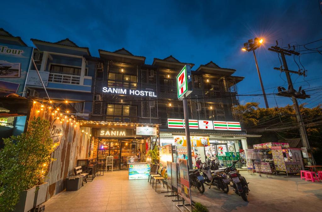 a building with a sigma hotel at night at Sanim Hostel in Ao Nang Beach
