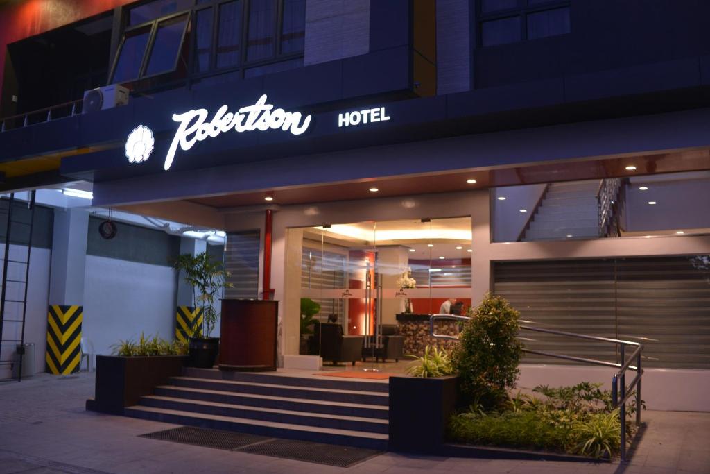 a hotel with a sign on the front of it at Robertson Hotel in Naga