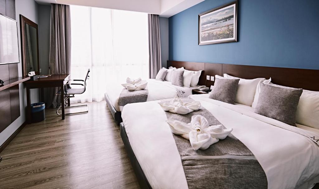 Postel nebo postele na pokoji v ubytování Meritin Hotel