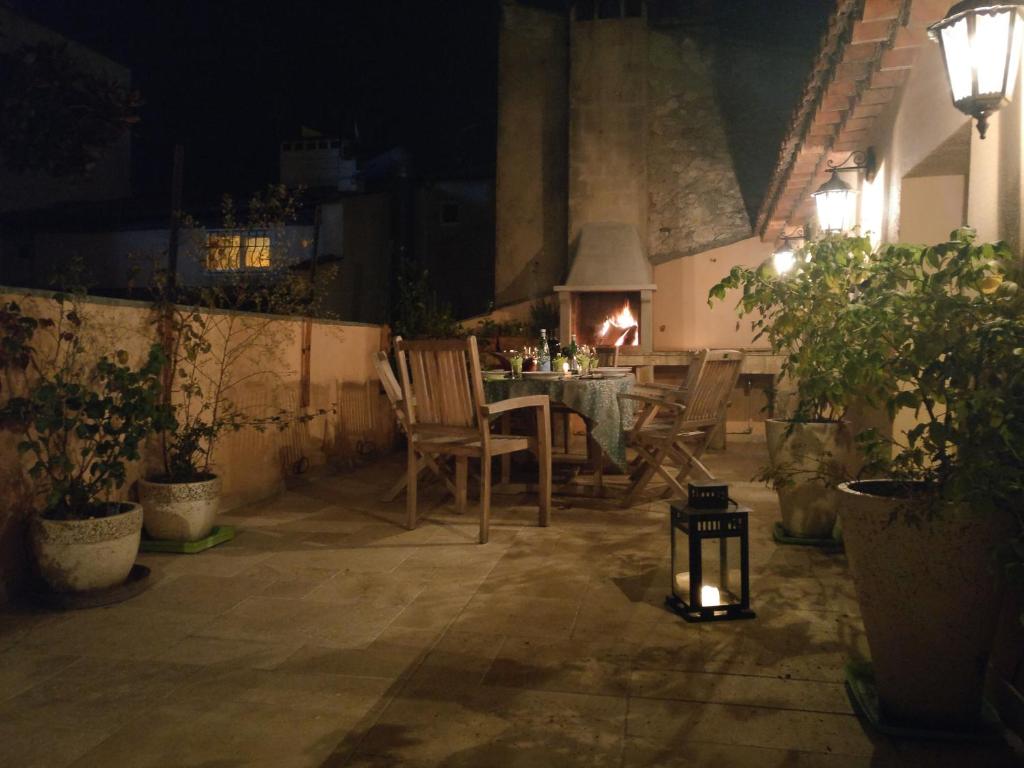 a patio with a table and chairs at night at Chateau Clemenceau in Antibes