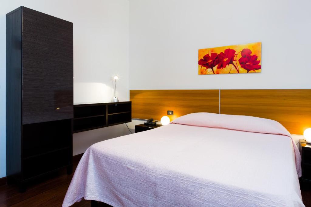 Postel nebo postele na pokoji v ubytování Hotel Adria