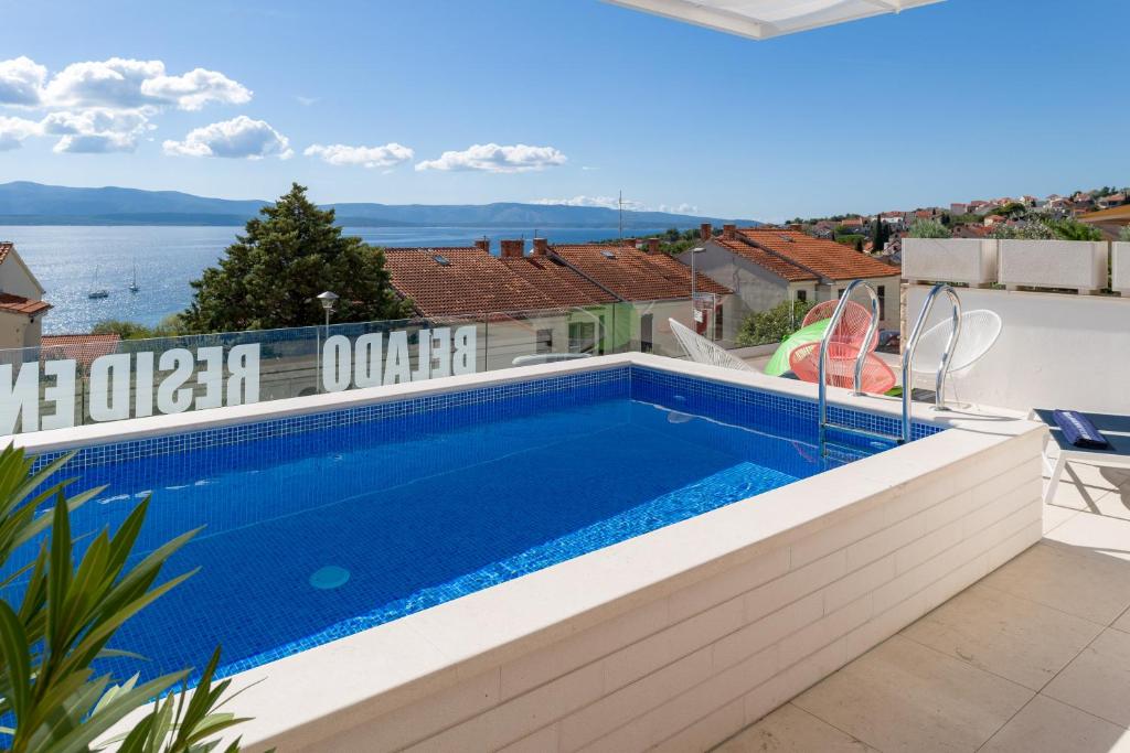 a swimming pool on the roof of a house at Belado Residence Bol in Bol