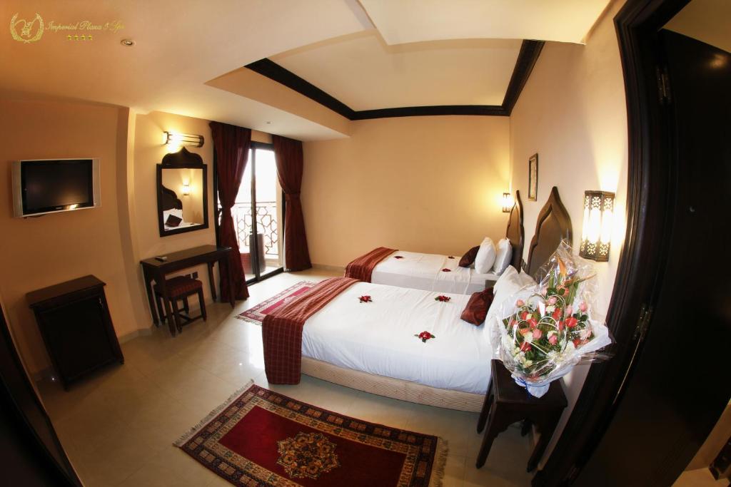 Postel nebo postele na pokoji v ubytování Hotel Imperial Plaza & Spa