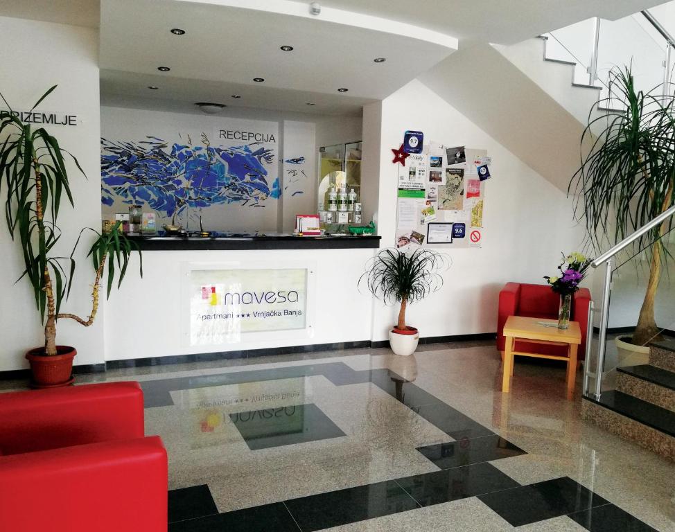 a lobby of a pharmacy with plants and a counter at Apartments Mavesa in Vrnjačka Banja